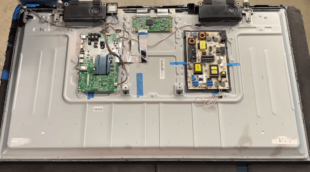 Hisense TV back panel removed revealing the power supply board and main board