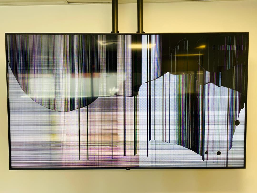 A clear photo of a damaged Hisense screen with impact point and radiating cracks