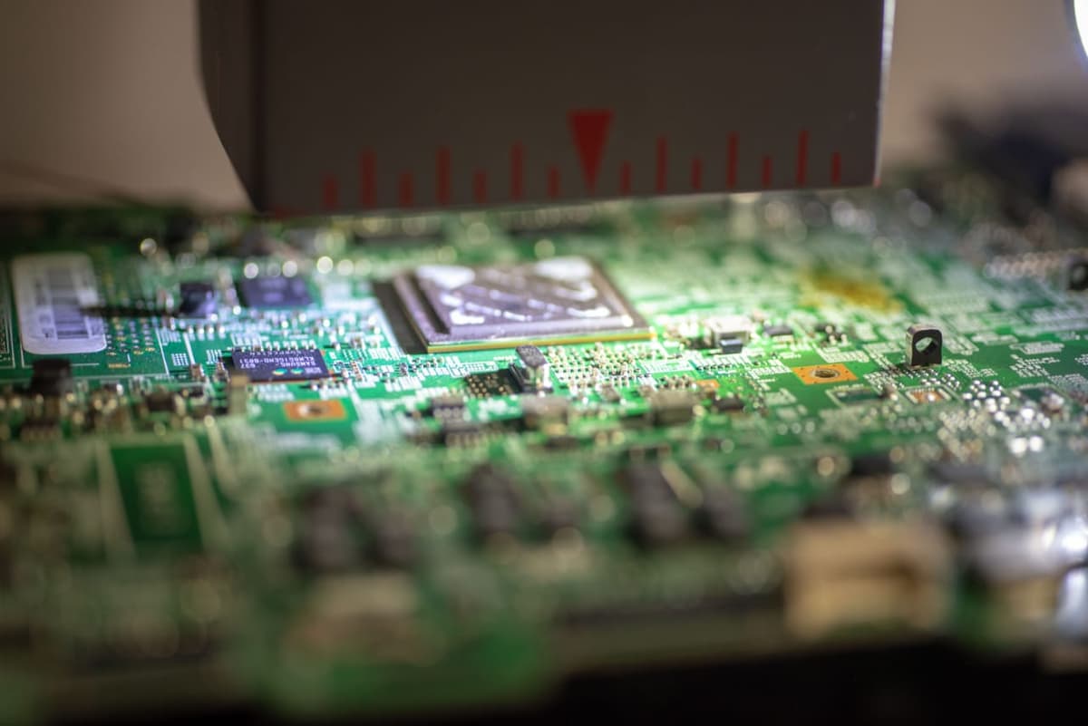 Board on BGA rework station being repaired by a technician