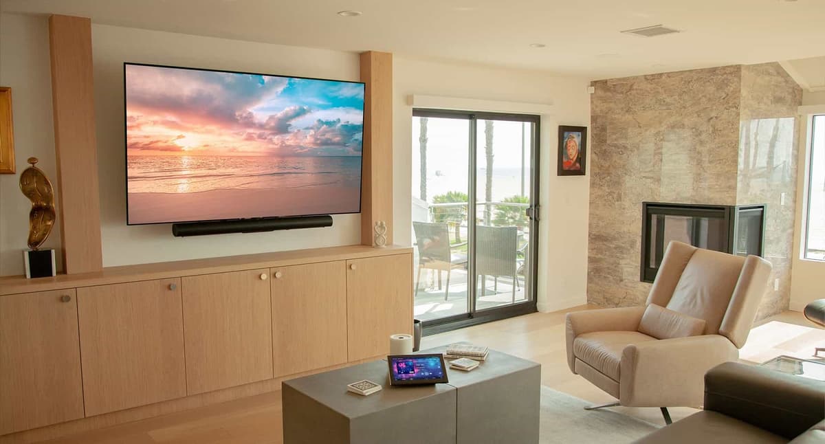 Home living room with a large screen TV and surround sound speakers